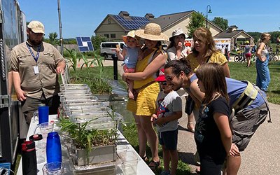 People looking at soils samples on a table showing different land use types